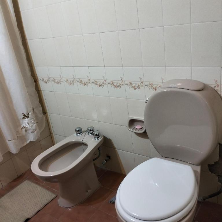 a bathroom with a white toilet and a bidet at La morada salteña in Salta