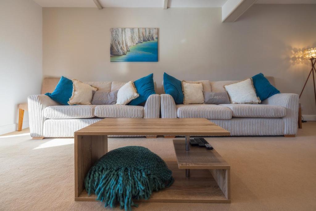 a living room with a couch and a coffee table at The Secret Garden - West Sussex - 3BR House with Drive in Crawley
