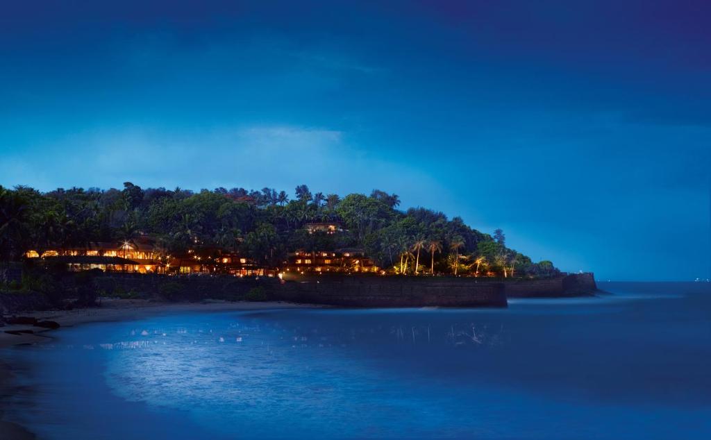 
a large body of water with a lighthouse at Taj Fort Aguada Resort & Spa, Goa in Candolim
