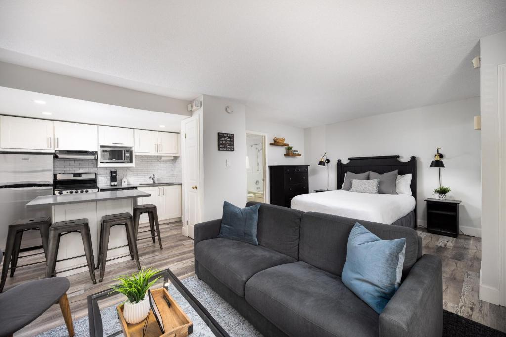 a living room with a couch and a bed at Studio Condo @ North Creek|Pool/Hot Tub/Crave TV in Blue Mountains