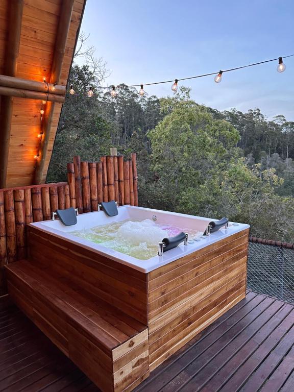 a hot tub on the deck of a house at ThanSam Cabaña in San Vicente