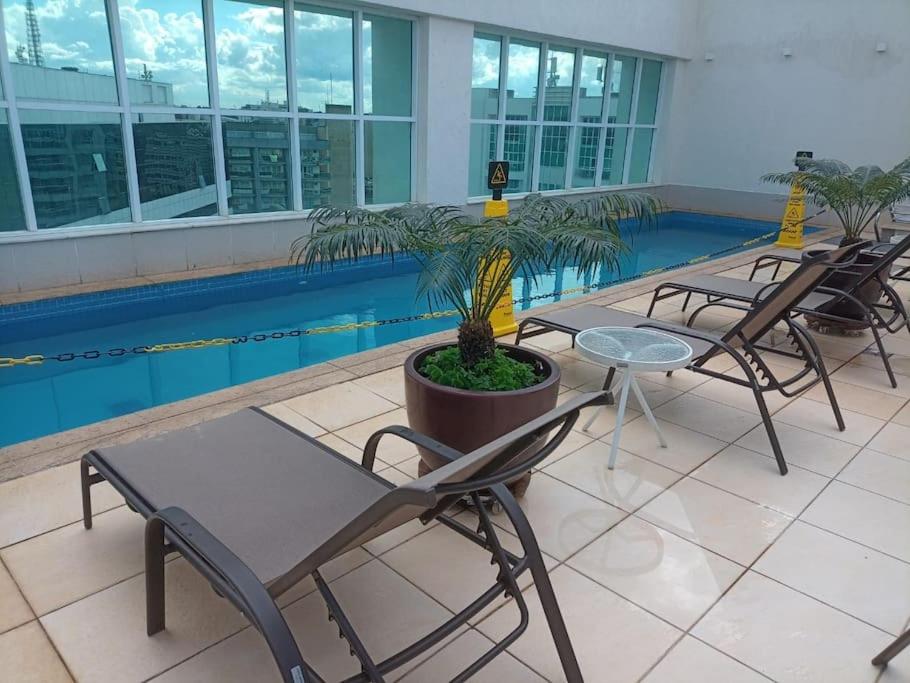 a group of chairs and a table and a pool at Flat Particular Marizienne Hotel Saint Moritz 31 in Torto