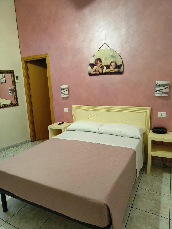 Postel nebo postele na pokoji v ubytování Hotel PRINCIPE AMEDEO