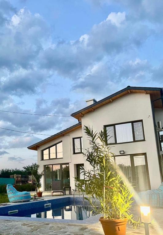 a house with a swimming pool in front of it at Guest house Villa Orlovo in Orlovo