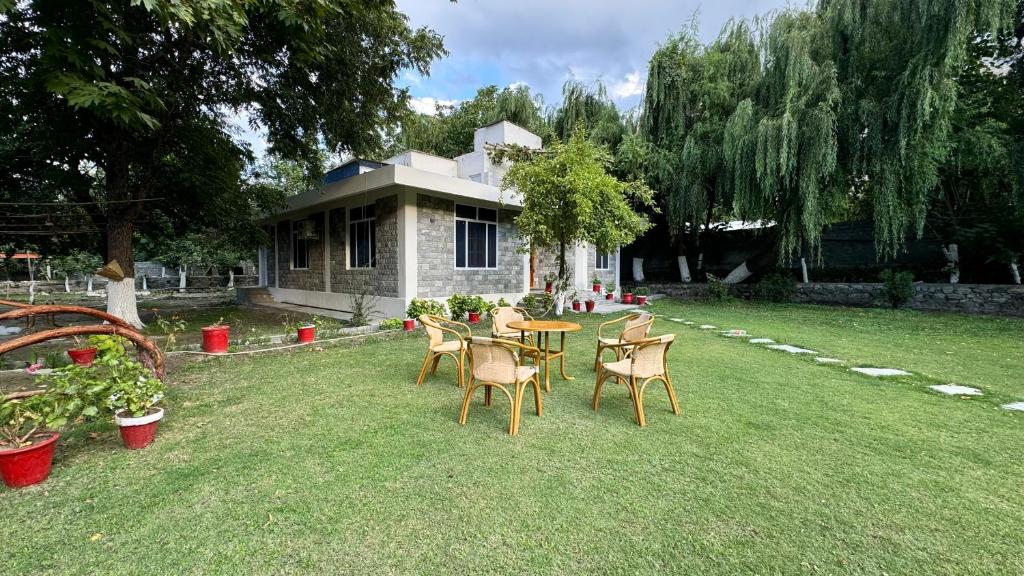 a table and chairs in the yard of a house at The Pecan Resort in Gilgit