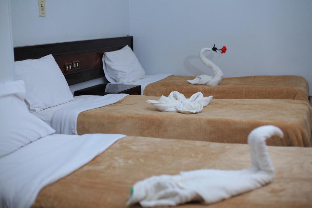 Postel nebo postele na pokoji v ubytování Oscar Hotel