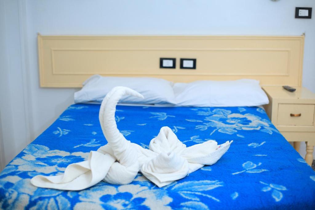 Postel nebo postele na pokoji v ubytování Oscar Hotel