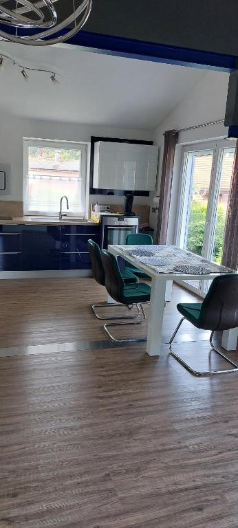 a kitchen with a table and chairs in a room at Elaine in Schongau