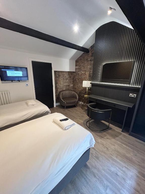 a hotel room with a bed and a piano at 10 Hockenhall - Liverpool's Oldest House in Liverpool
