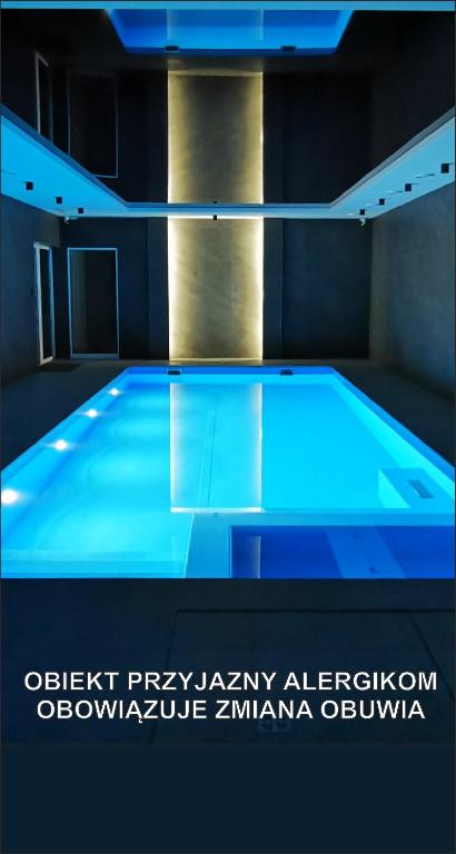 a swimming pool with blue lighting in a room at Widokowy Szczawnica in Szczawnica