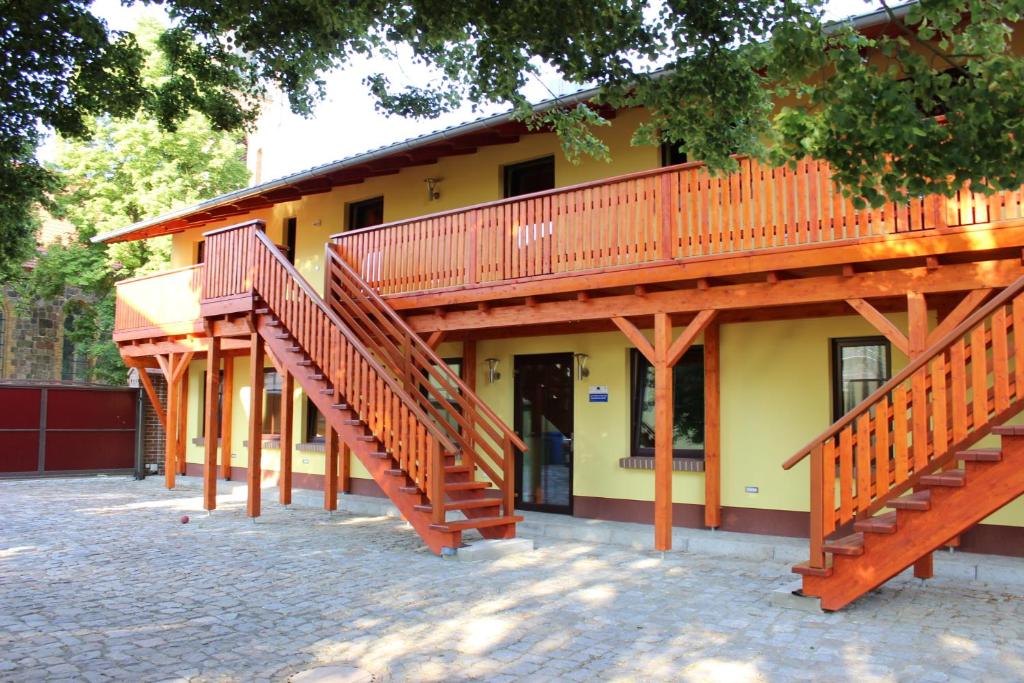 a building with wooden stairs in front of it at L&L Skaters Home in Langenlipsdorf