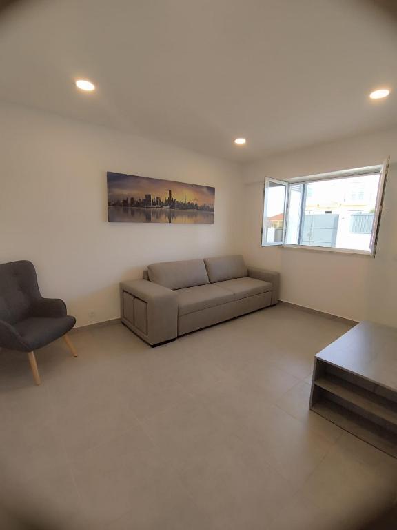 a living room with a couch and a chair at Casa lisboa in Livramento