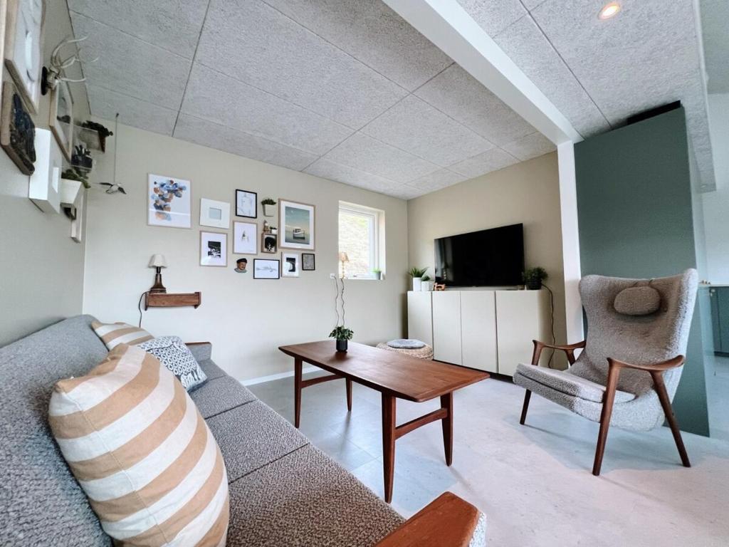 a living room with a couch and a table at Stunning 3 Bedroom Family Friendly Retreat in Tvøroyri