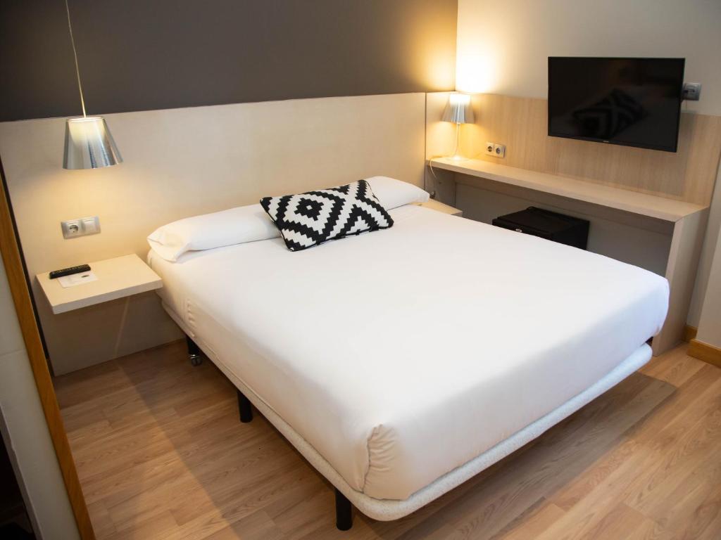Postel nebo postele na pokoji v ubytování Hotel Restaurante Cadosa
