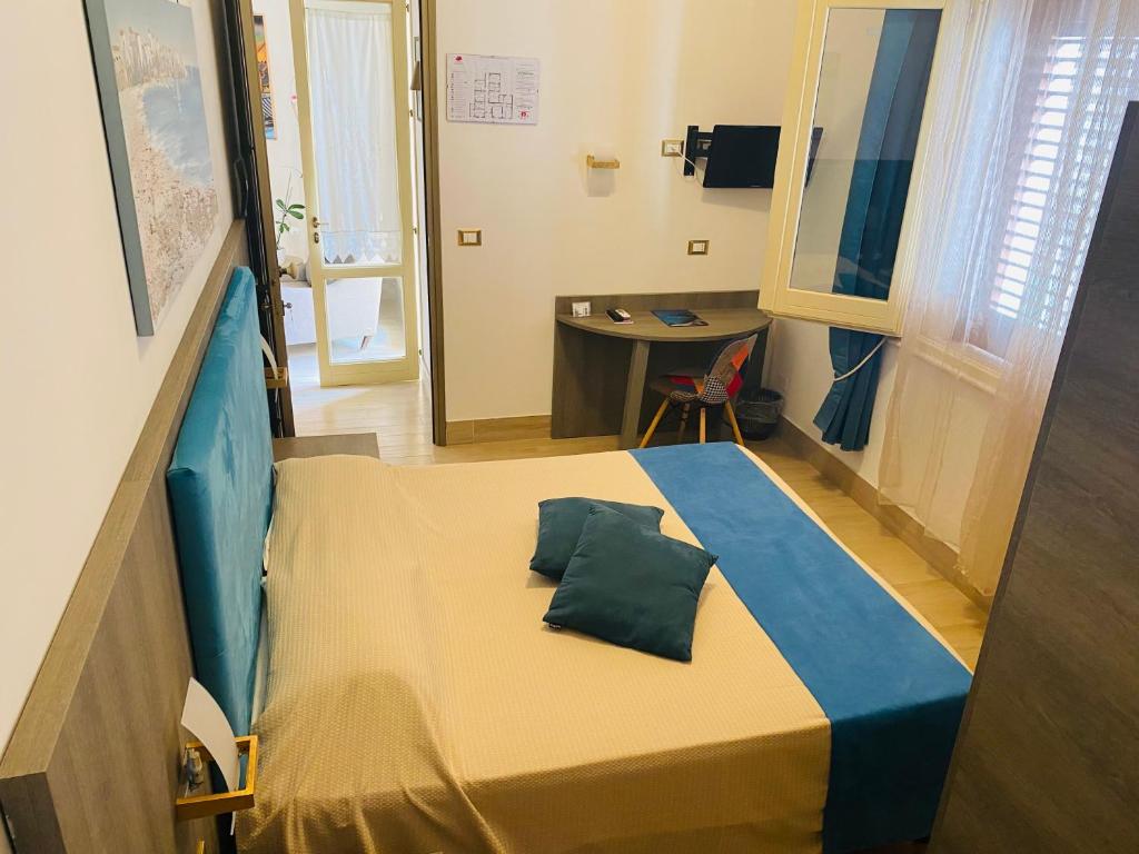 una camera da letto con un letto con un cuscino sopra di Albergo Bouganville a Favignana