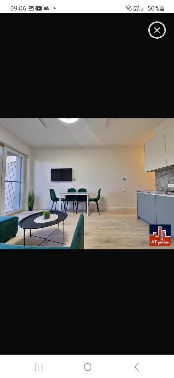 a living room with two tables and a couch at Apartamentai in Palanga
