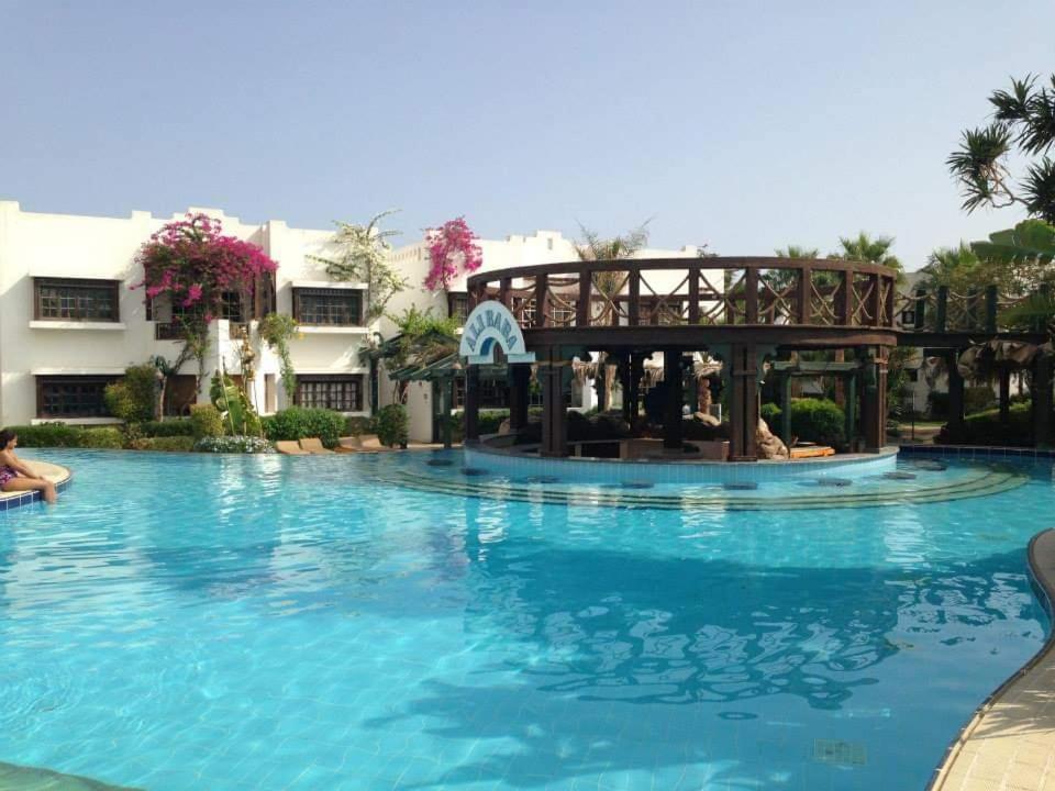 a swimming pool at a resort at 2 Bedroom apartment on luxury delta Sharm resort in Sharm El Sheikh