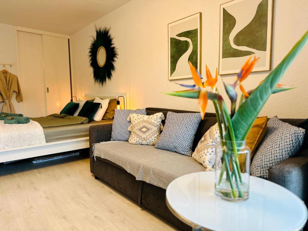 a living room with a couch and a bed at Studio Los Cristianos Atlantic View in Los Cristianos