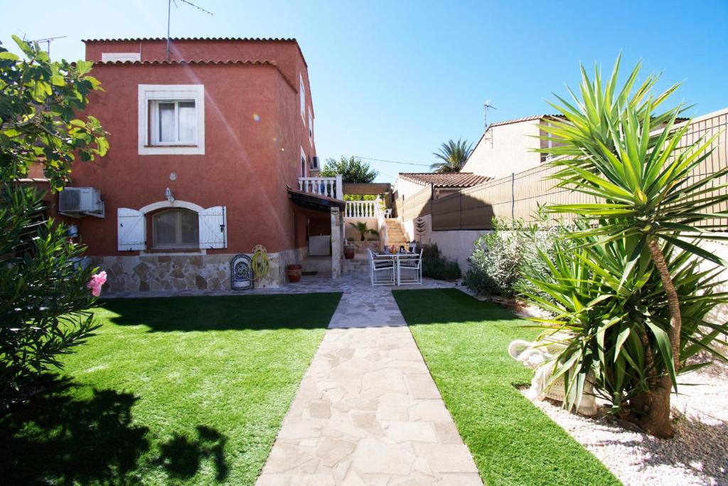 un patio de una casa con césped en L'Escale Standing Presta, en La Valette-du-Var
