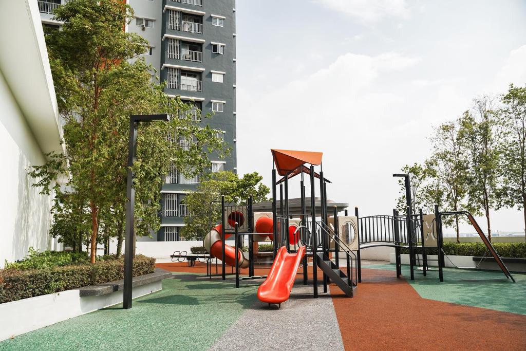 a playground with a slide at Family Deluxe 2 BR by KLIA Airport Homestay in Sepang