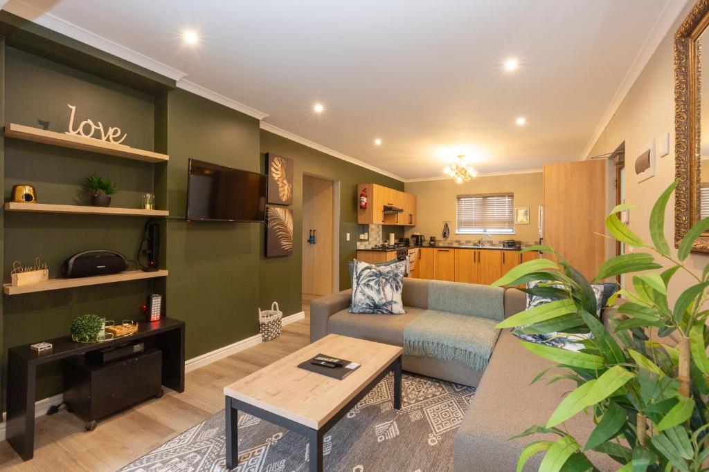 a living room with a couch and a table at Ellefsen 134 Golf Paradise - NEWLY RENOVATED! in Langebaan