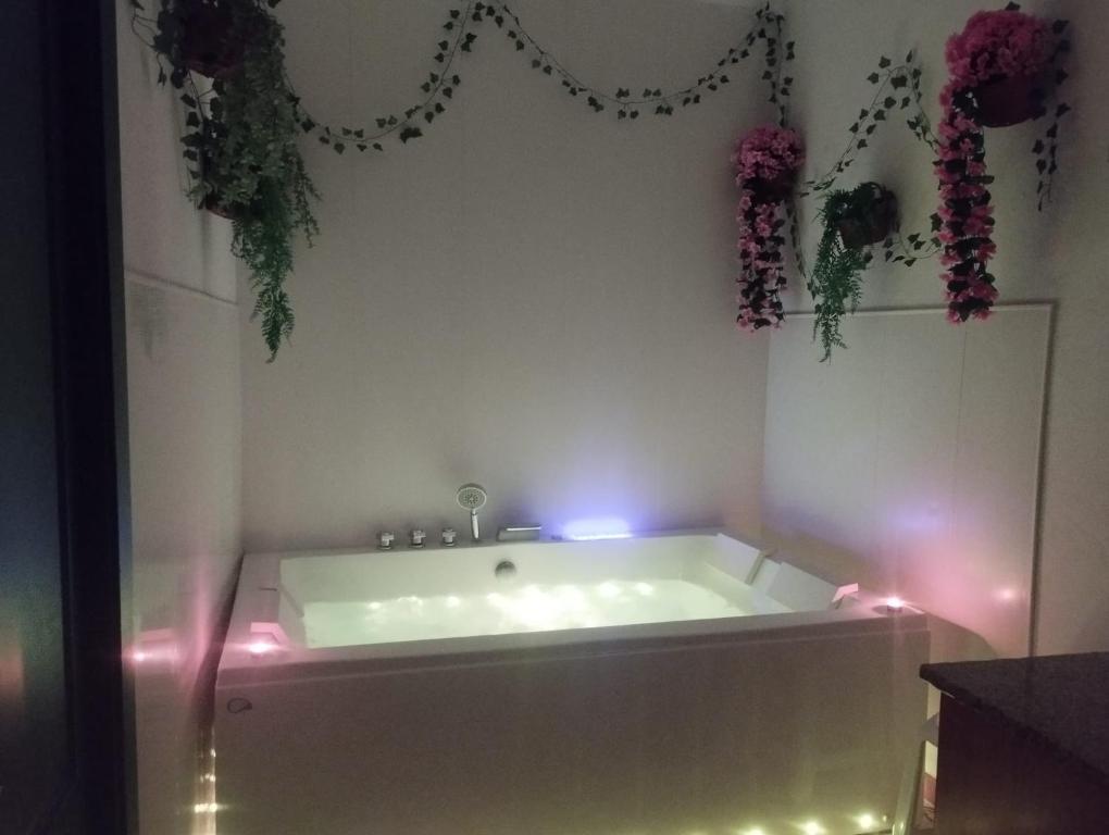 a white bath tub with lights in a bathroom at Casa Rural Majaceite in El Bosque