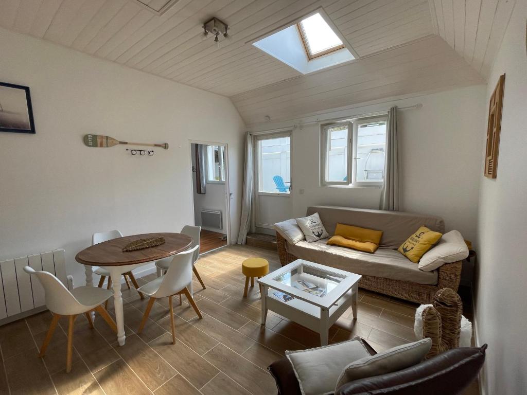 a living room with a couch and a table at Pen Ty Armor maison de pêcheur proche mer au calme in Trébeurden