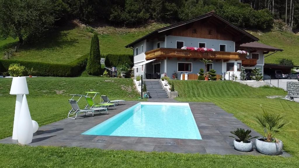 a house with a swimming pool in front of a house at Unterbleiwanghof in Radstadt