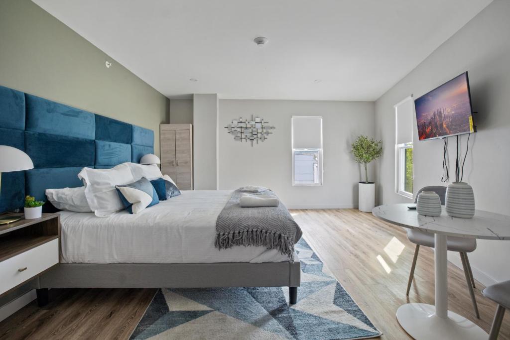 a bedroom with a bed with a blue headboard at Cottage Suites in Middletown