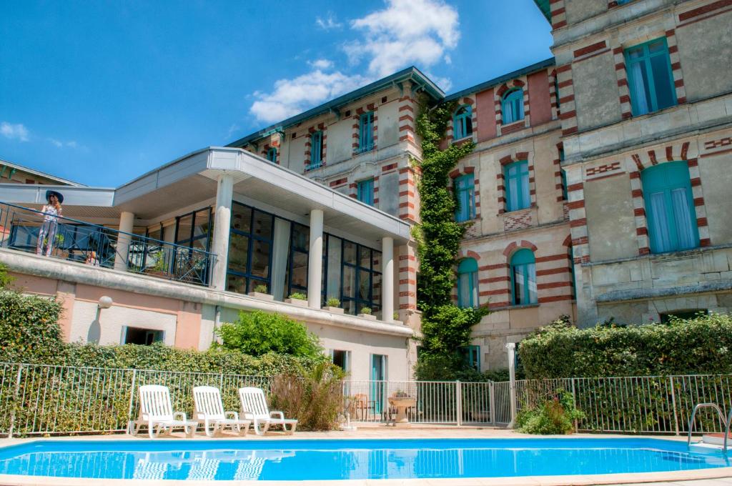 a building with a swimming pool in front of a building at Résidence de Tourisme Vacances Bleues Villa Regina in Arcachon
