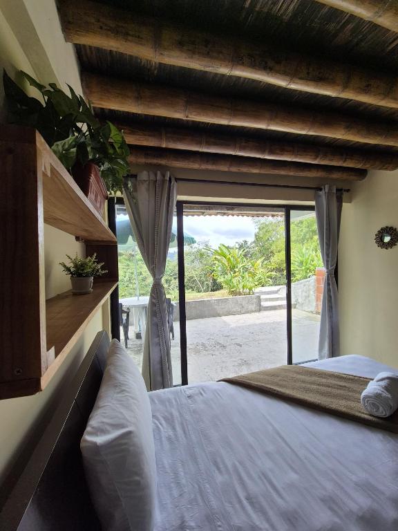 a bedroom with a bed and a large window at Bhutan Filandia in Filandia