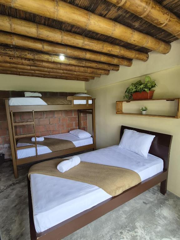 a room with two beds in a room with at Bhutan Filandia in Filandia