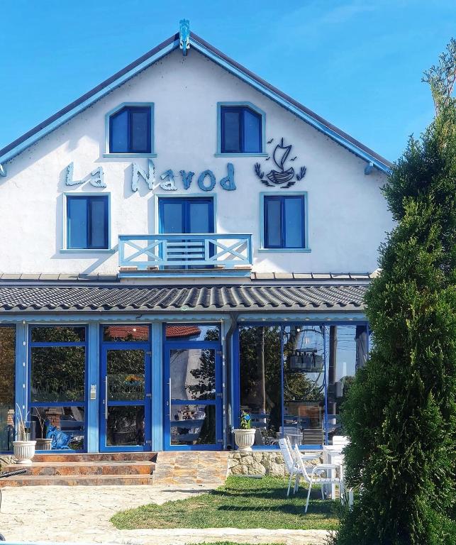 a building with a sign on the front of it at La Navod Jurilovca in Jurilovca
