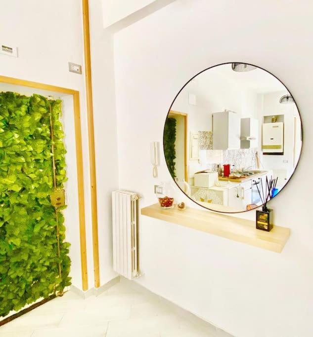 a mirror on a wall next to a room at Essenza3 0 in Salerno