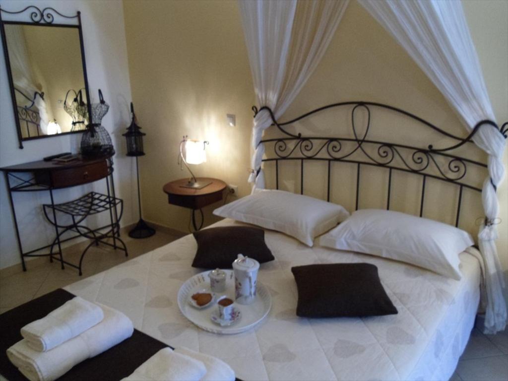 um quarto com uma cama grande e uma bandeja de comida. em Garden Villa em Ioannina