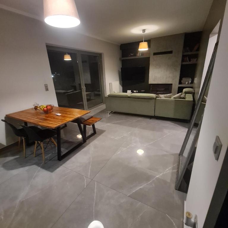 a living room with a wooden table and a couch at Eleusis modern flat,carpark in in Elefsina