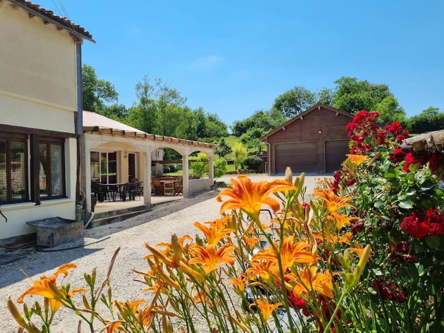a garden with orange flowers in front of a building at Gite Ker Amance Dienville - 10 personnes in Dienville