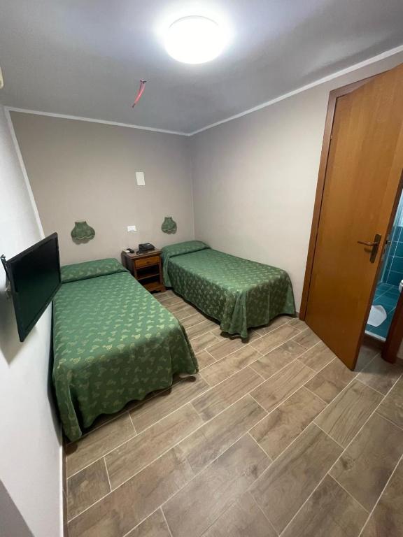 Postel nebo postele na pokoji v ubytování Hotel Cortese