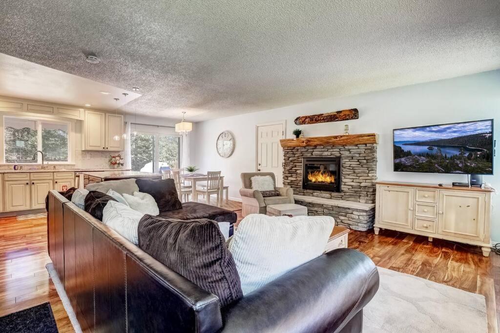 a living room with a couch and a fireplace at Cheyenne Chalet - Perfect little rancher in SLT! in Mevers