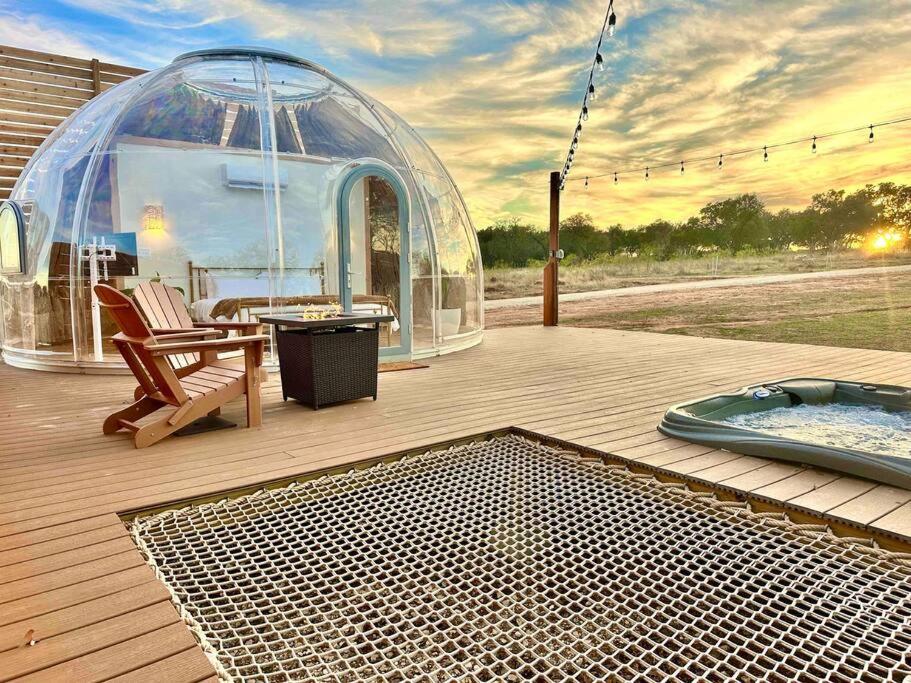 a gazebo on a deck with a hot tub and a igloo at Draco at the Retreat in Fredericksburg