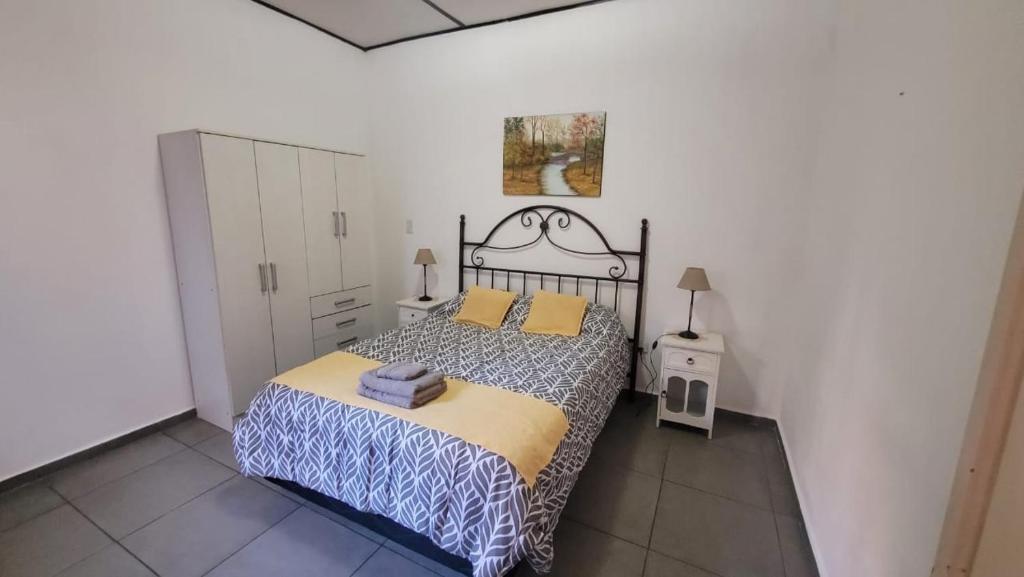 a bedroom with a bed in a white room at Departamento Mis Nonos 4 in Mendoza