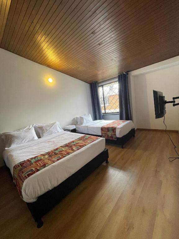 Postel nebo postele na pokoji v ubytování Bamuka Hostal