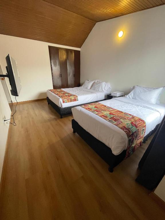 Postel nebo postele na pokoji v ubytování Bamuka Hostal