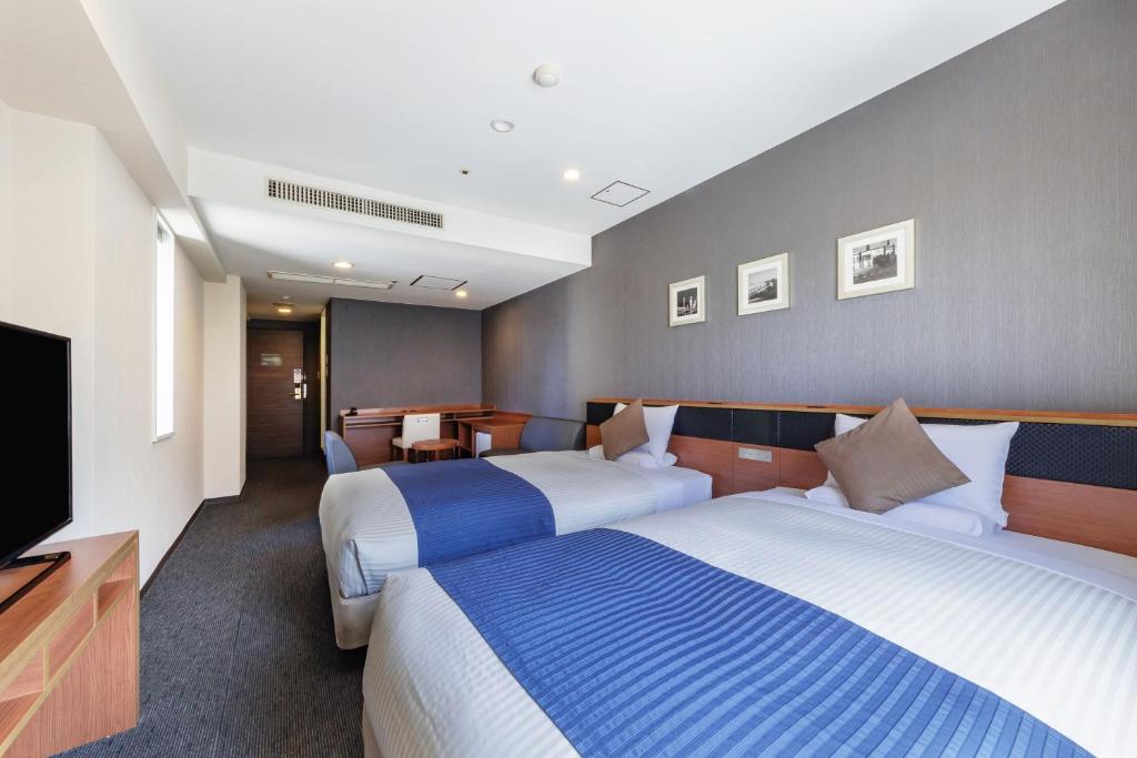 Postel nebo postele na pokoji v ubytování HOTEL MYSTAYS Nagoya Sakae