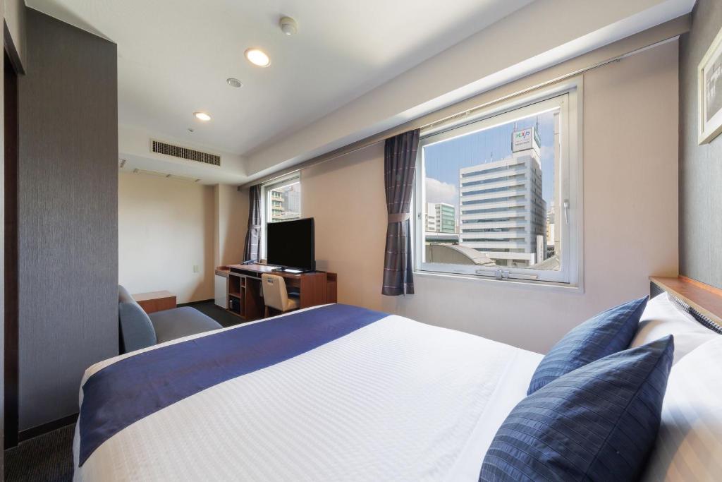 Postel nebo postele na pokoji v ubytování HOTEL MYSTAYS Nagoya Sakae