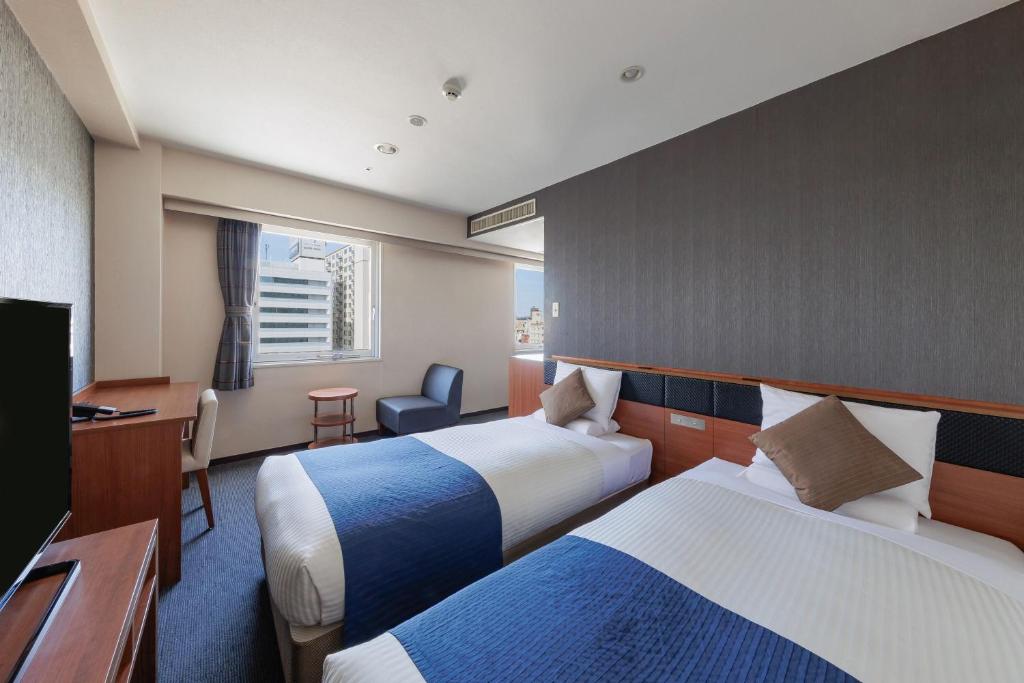 Postel nebo postele na pokoji v ubytování HOTEL MYSTAYS Nagoya Sakae