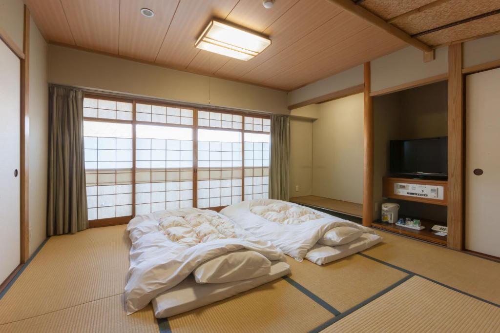 Postel nebo postele na pokoji v ubytování Onomichi Royal Hotel