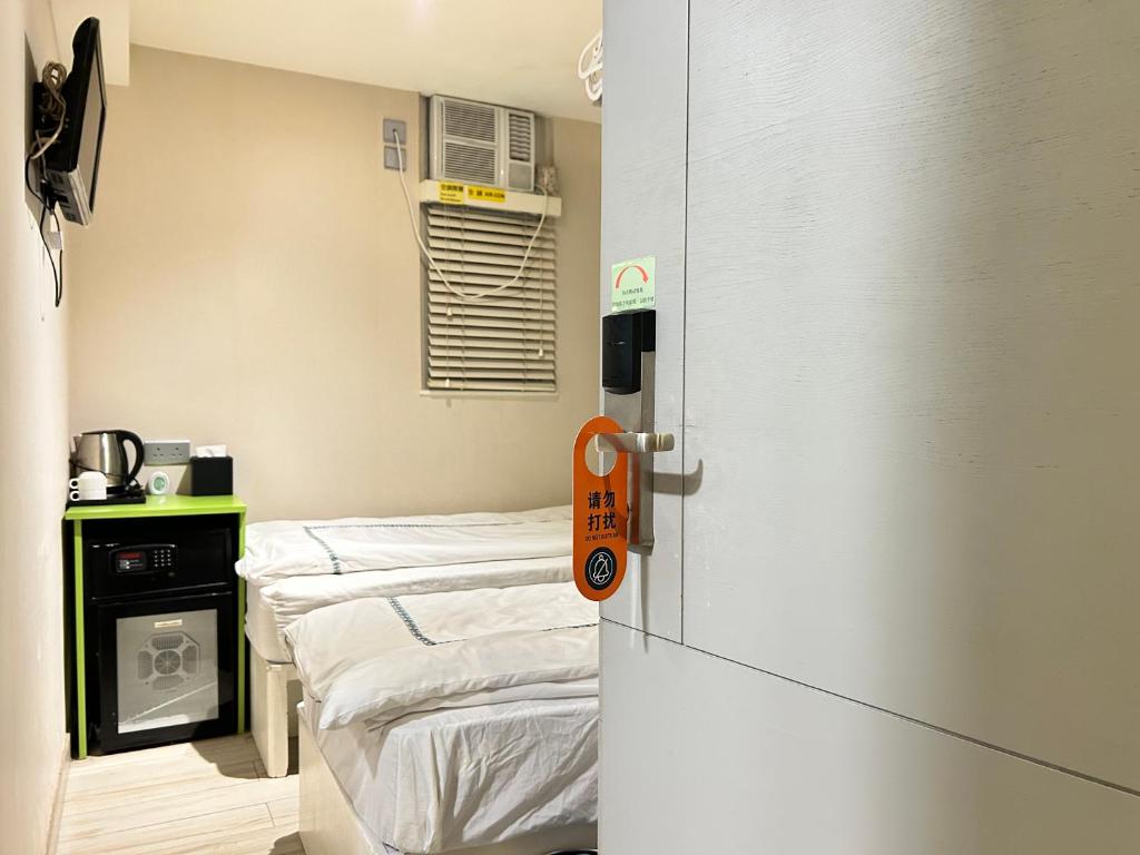 Postel nebo postele na pokoji v ubytování 珀依旅馆 Pop E INN