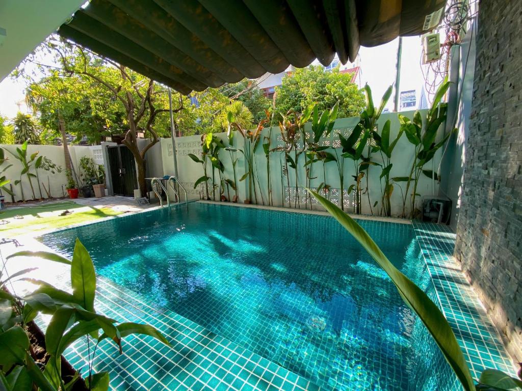 a swimming pool in a yard with plants at The Local Villa Danang in Da Nang