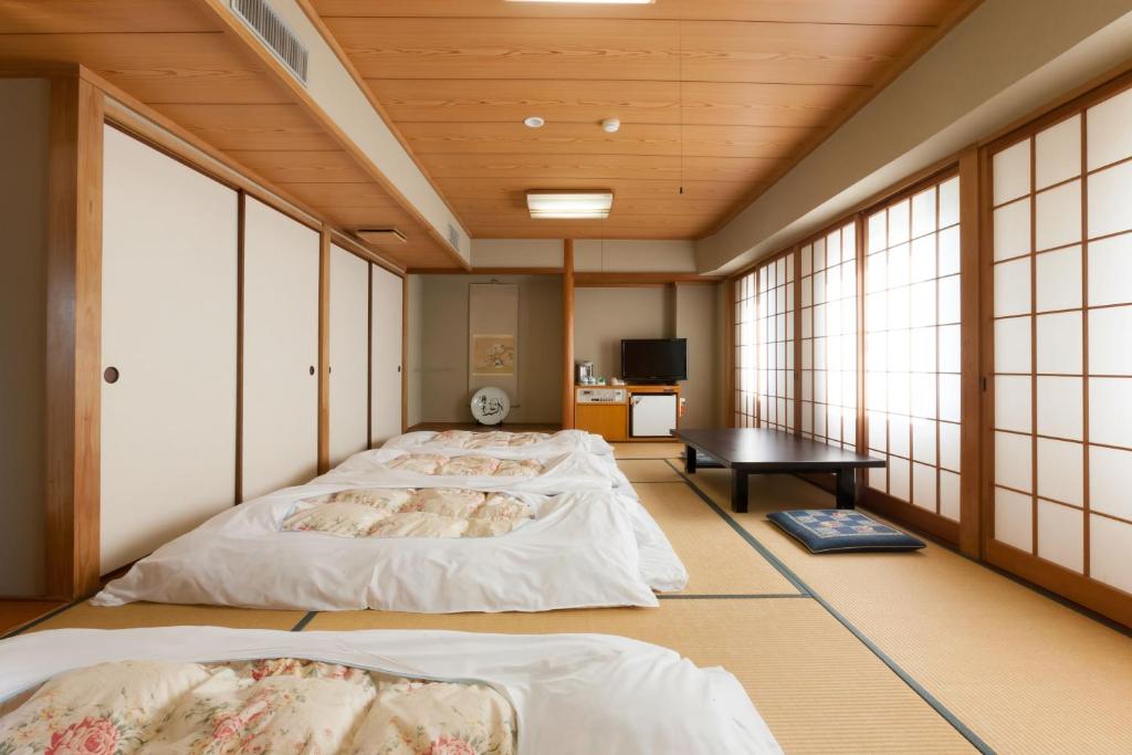 Postel nebo postele na pokoji v ubytování Onomichi Royal Hotel